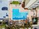 L-shaped community pool with plenty of lounge chairs at 851 Bayway Blvd # 104, Clearwater Beach, FL 33767