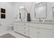 Double vanity bathroom with white cabinets, quartz countertops, and brass hardware at 4117 W Euclid Ave, Tampa, FL 33629