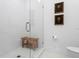 Bathroom with a glass shower, wooden bench, and hexagon tile floor at 4117 W Euclid Ave, Tampa, FL 33629