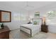 Well-lit bedroom with a queen bed, wood dresser, and white shutters at 4117 W Euclid Ave, Tampa, FL 33629