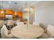 Elegant dining room with a large round table and a view into the kitchen at 6002 Printery St # 103, Tampa, FL 33616