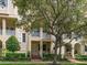 House exterior showcasing a two-story building with balconies and lush landscaping at 6002 Printery St # 103, Tampa, FL 33616