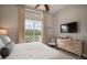 Spacious bedroom with private balcony and a dresser at 6002 Printery St # 103, Tampa, FL 33616