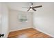 Well-lit bedroom, featuring hardwood floors and a ceiling fan at 8320 Boxwood Dr, Tampa, FL 33615