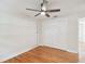 Bright bedroom with hardwood floors, ceiling fan, and ample closet space at 8320 Boxwood Dr, Tampa, FL 33615