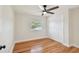 Light-filled bedroom featuring hardwood floors and a double door closet at 8320 Boxwood Dr, Tampa, FL 33615