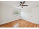 Spacious bedroom with hardwood floors, ceiling fan and access to hallway at 8320 Boxwood Dr, Tampa, FL 33615