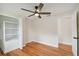 Bright bedroom with hardwood floors, ceiling fan, and ample closet space at 8320 Boxwood Dr, Tampa, FL 33615