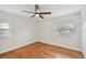 Bright bedroom with hardwood floors, two windows, and ceiling fan at 8320 Boxwood Dr, Tampa, FL 33615