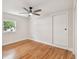 Light-filled bedroom featuring hardwood floors, a ceiling fan and built-in closet at 8320 Boxwood Dr, Tampa, FL 33615