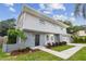 Two-story home with gray exterior, landscaping, and attached two-car garage at 8320 Boxwood Dr, Tampa, FL 33615