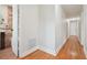 Long hallway with wood flooring and access to bedrooms at 8320 Boxwood Dr, Tampa, FL 33615