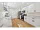 Modern kitchen with white cabinets, quartz countertops, and stainless steel appliances at 8320 Boxwood Dr, Tampa, FL 33615