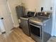 Laundry room with LG washer and dryer, water heater, and wood flooring at 8320 Boxwood Dr, Tampa, FL 33615