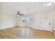 Living room with bay window, ceiling fan, and hardwood floors at 8320 Boxwood Dr, Tampa, FL 33615