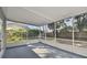 Relaxing screened porch overlooks backyard with a wooden fence at 8320 Boxwood Dr, Tampa, FL 33615