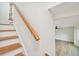 Wooden staircase leads to upper level with a view to living area at 8320 Boxwood Dr, Tampa, FL 33615