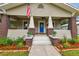 Charming craftsman home with a welcoming front porch and landscaped yard at 104 W Henry Ave, Tampa, FL 33604