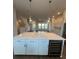 Modern kitchen island with white cabinets and quartz countertops at 7404 Newham Ln, Sarasota, FL 34240