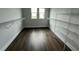 Spacious walk-in closet with ample shelving and dark wood floors at 7404 Newham Ln, Sarasota, FL 34240