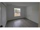 Bedroom with a large window, gray flooring, and a double door closet at 14018 Barlington St, Spring Hill, FL 34609