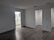 Spacious bedroom with gray vinyl flooring, an ensuite bathroom, and a walk-in closet at 14018 Barlington St, Spring Hill, FL 34609