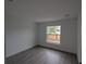 Bright bedroom with large window and grey laminate flooring at 14018 Barlington St, Spring Hill, FL 34609