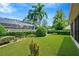 Landscaped backyard with green lawn and hedges at 806 Red Ash Ct, Seffner, FL 33584