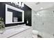 Modern bathroom with a glass shower and dark accent wall at 806 Red Ash Ct, Seffner, FL 33584