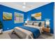 Bedroom with blue walls and a comfortable bed at 806 Red Ash Ct, Seffner, FL 33584