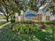 Lake Weeks community entrance with stone and landscaping at 806 Red Ash Ct, Seffner, FL 33584