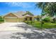 Two-story house with three-car garage, landscaping, and a mailbox at 806 Red Ash Ct, Seffner, FL 33584