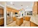 Modern kitchen with island, stainless steel appliances, and wood cabinets at 806 Red Ash Ct, Seffner, FL 33584