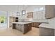 Modern kitchen with two-toned cabinetry, quartz countertops, and large island at 4608 Majestic Hills Loop, Brooksville, FL 34601