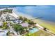 Stunning aerial view showcasing a beautiful beach, sports courts, parking, and Sunset Grill, with easy access to the ocean at 905 Seagrape Dr, Ruskin, FL 33570