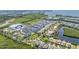 Aerial view showcases waterfront homes, a marina, and lush greenery at 905 Seagrape Dr, Ruskin, FL 33570