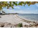 White sand beach with calm water and a beachfront restaurant at 905 Seagrape Dr, Ruskin, FL 33570