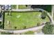 Aerial view of a fenced dog park with benches and shaded areas at 905 Seagrape Dr, Ruskin, FL 33570