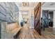 Stunning foyer with textured accent wall, barn door, and wood-look tile flooring at 905 Seagrape Dr, Ruskin, FL 33570