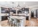 Modern kitchen with dark cabinetry, quartz countertops, and an island at 905 Seagrape Dr, Ruskin, FL 33570