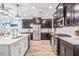 Modern kitchen with dark wood cabinets, stainless steel appliances, and quartz countertops at 905 Seagrape Dr, Ruskin, FL 33570