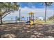 playground with a slide and monkey bars near the waterfront at 905 Seagrape Dr, Ruskin, FL 33570