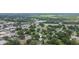 Aerial view of a home in a lush neighborhood with commercial businesses nearby at 14006 5Th St, Dade City, FL 33525