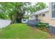 Backyard with large lawn, stairs to the back door, and shed in the back at 14006 5Th St, Dade City, FL 33525