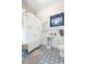 Bright bathroom featuring patterned tile floor, clawfoot tub, and a ducky-themed shower curtain at 14006 5Th St, Dade City, FL 33525