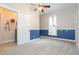 Bedroom with natural light, carpet, blue and white walls, ceiling fan, and white shelving at 14006 5Th St, Dade City, FL 33525