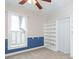 Bedroom with natural light, carpet, blue and white walls, ceiling fan, and white shelving at 14006 5Th St, Dade City, FL 33525