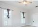 Bright bedroom featuring neutral walls and trim, two windows, and a closet with bi-fold doors at 14006 5Th St, Dade City, FL 33525