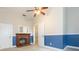 Bedroom featuring carpet, ceiling fan, natural light, blue and white walls and a charming brick fireplace at 14006 5Th St, Dade City, FL 33525