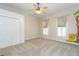 Bedroom featuring a closet, two windows with striped curtains, and a fun mural on the wall at 14006 5Th St, Dade City, FL 33525